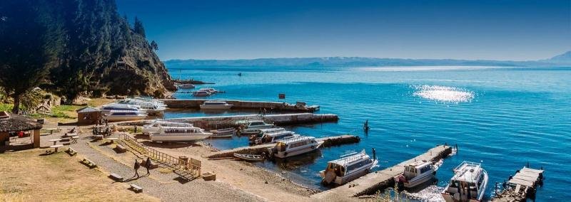Boat landing on Lake Titicaca Tour boats moored at stone jetties on the shore of Lake Titicaca