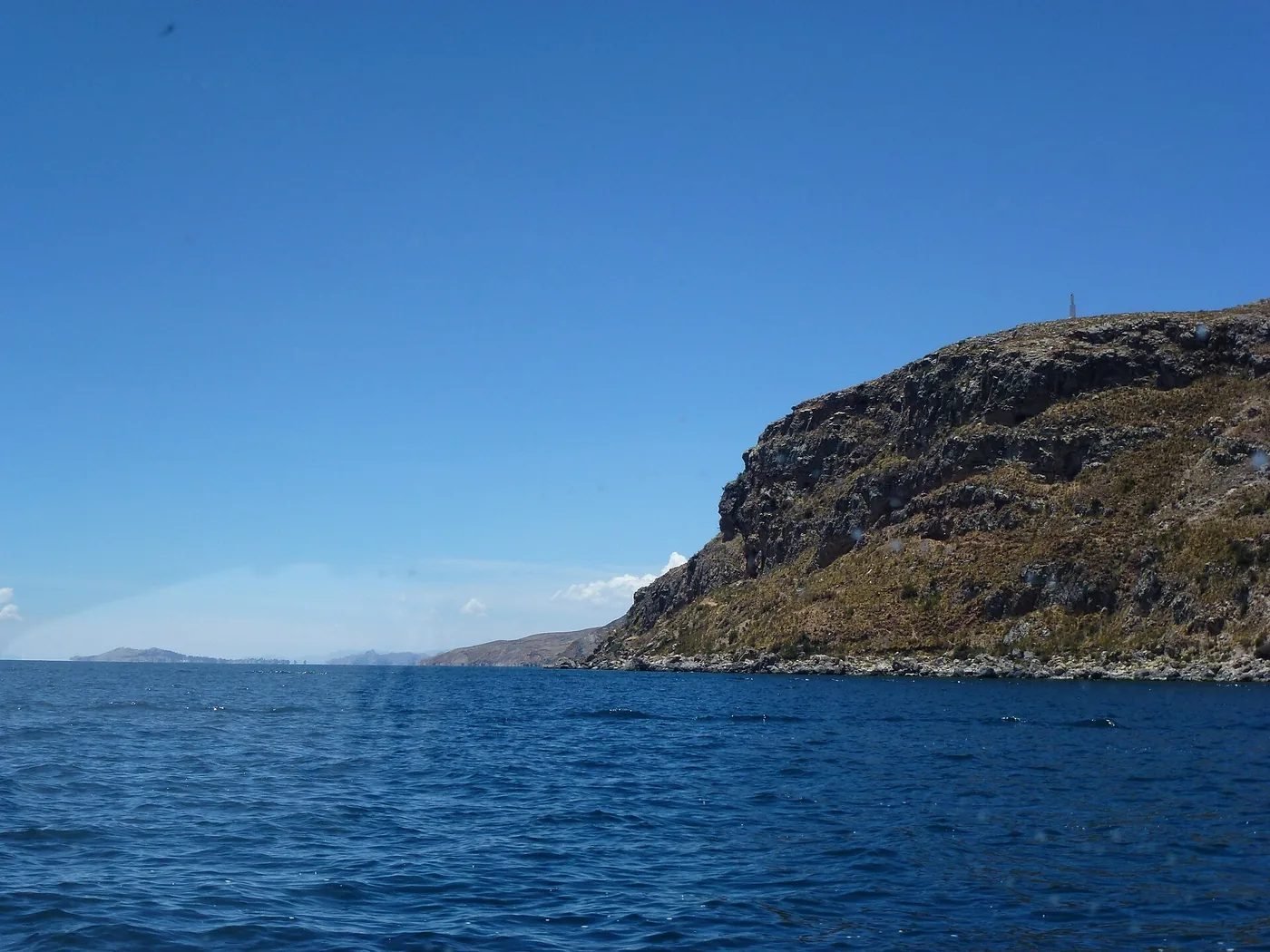 Lake Titicaca from Taquile island, terraced hillside above deep blue water