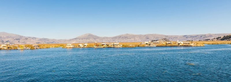 Reed houses and a reed boat on a Uros floating island