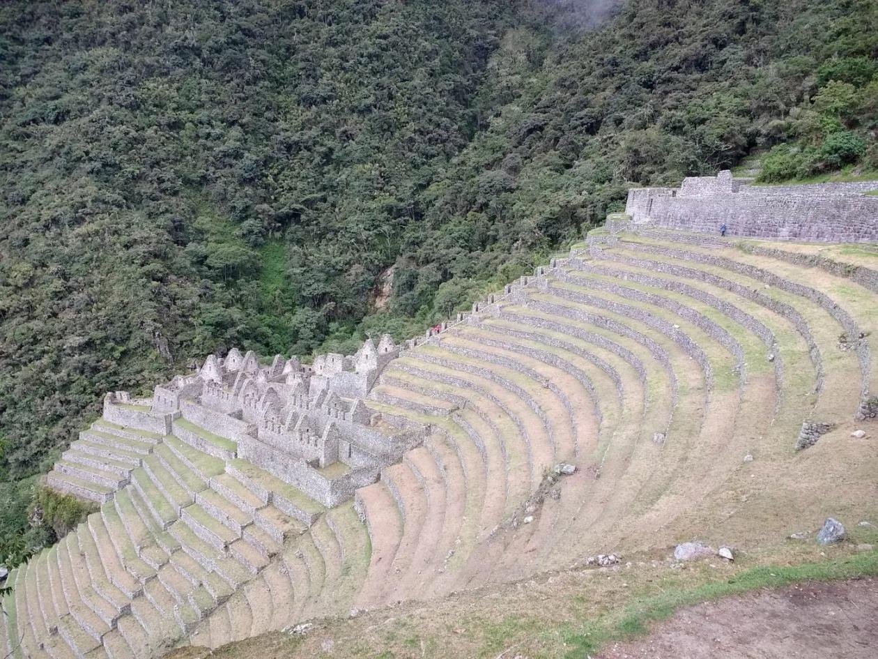 Curved Inca terraces and stone buildings of Wiñay Wayna on the Inca Trail