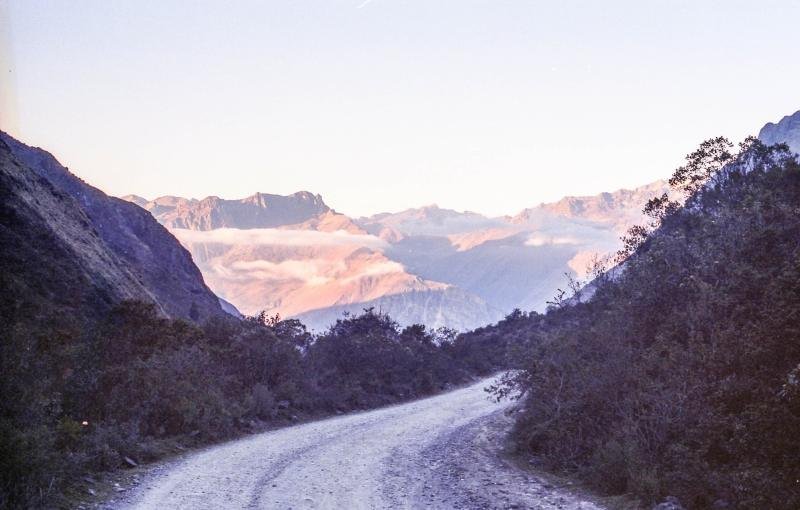 Dirt road winding down from Abra Malaga toward forested mountains