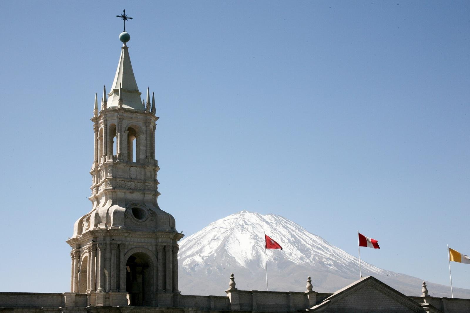 Arequipa cathedral tower and El Misti White stone bell tower of the Arequipa cathedral with the snow-capped cone of El Misti behind it