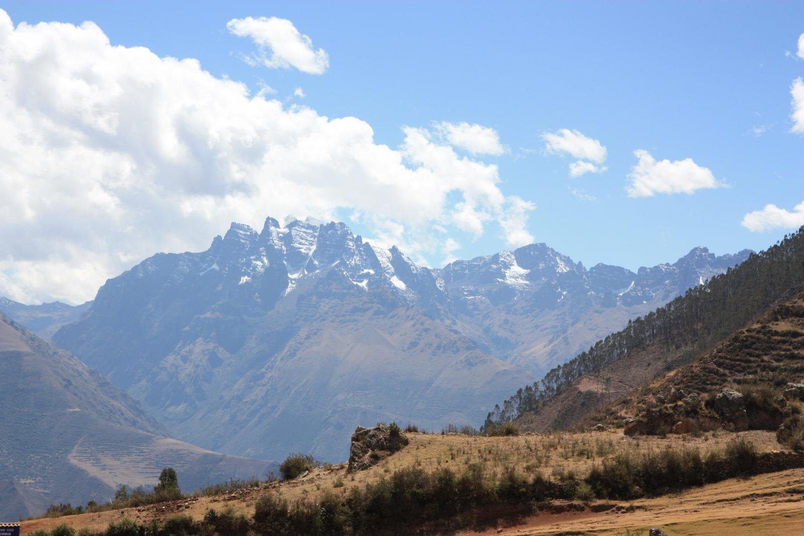 Dry golden hillside near Chinchero under a clear August sky Dry golden hillside near Chinchero under a clear August sky, with the snowy Urubamba range behind