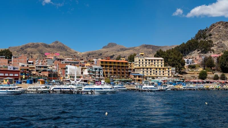 Waterfront of Copacabana with boats on Lake Titicaca and the hills behind
