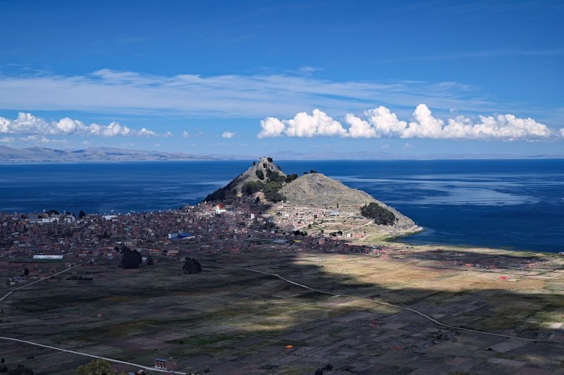 Copacabana bay on Lake Titicaca with tour boats moored below the hills