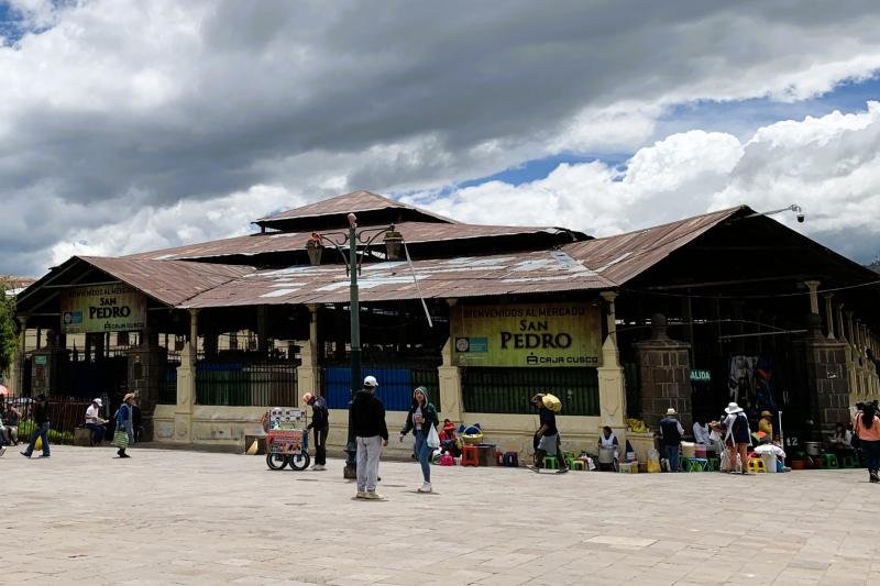 Main entrance of the San Pedro market in Cusco under a cloudy sky