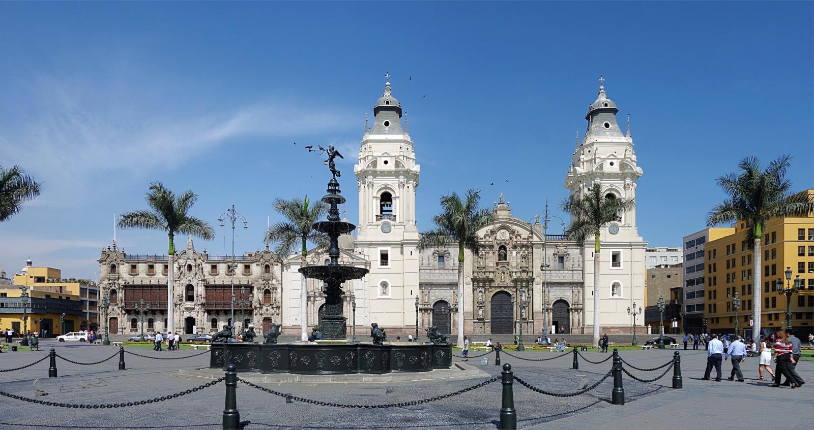 Lima Plaza Mayor of Lima with the cathedral, the bronze fountain and palm trees under a blue sky