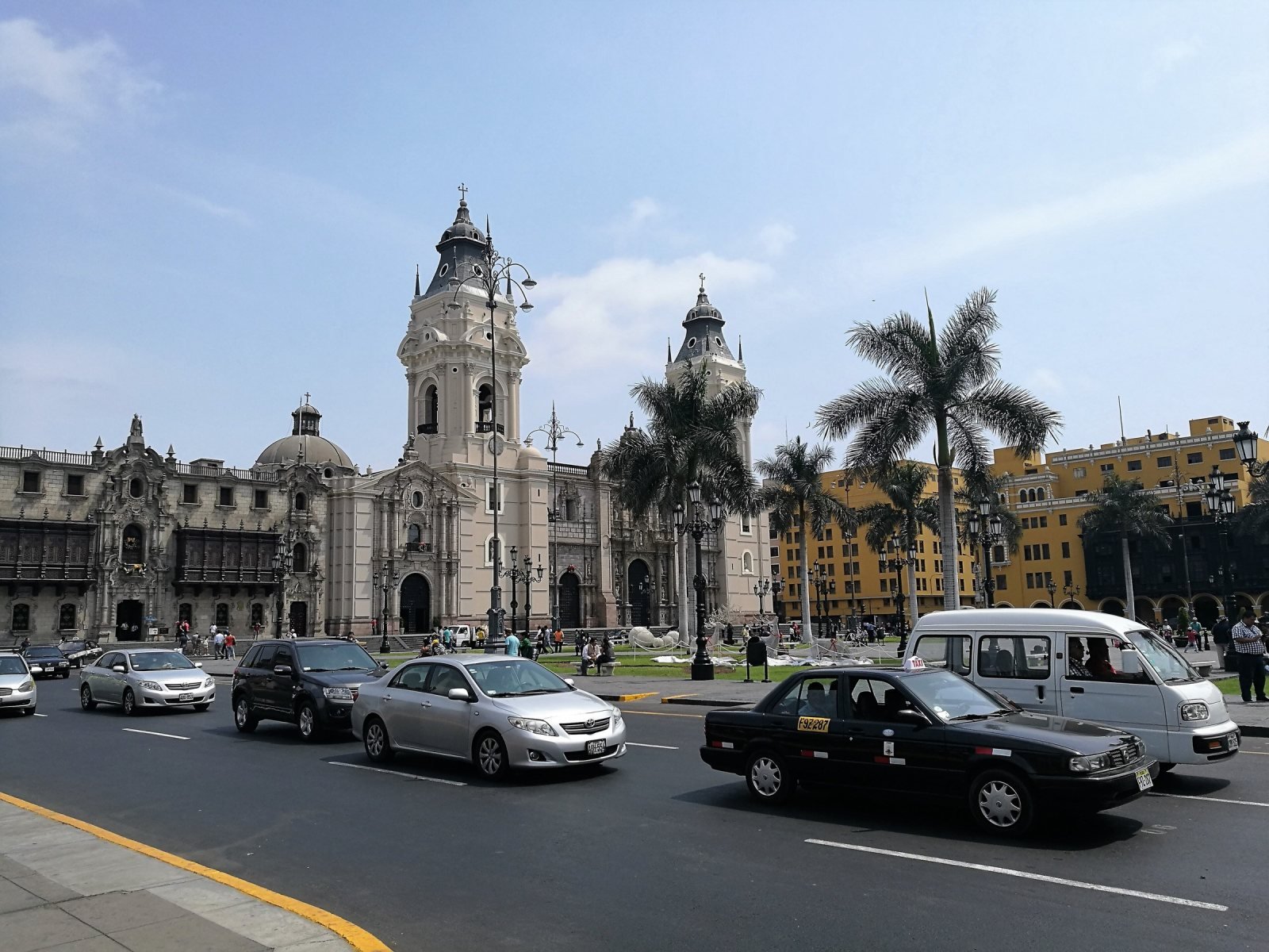 Plaza Mayor of Lima with the cathedral and palm trees under a gray sky
