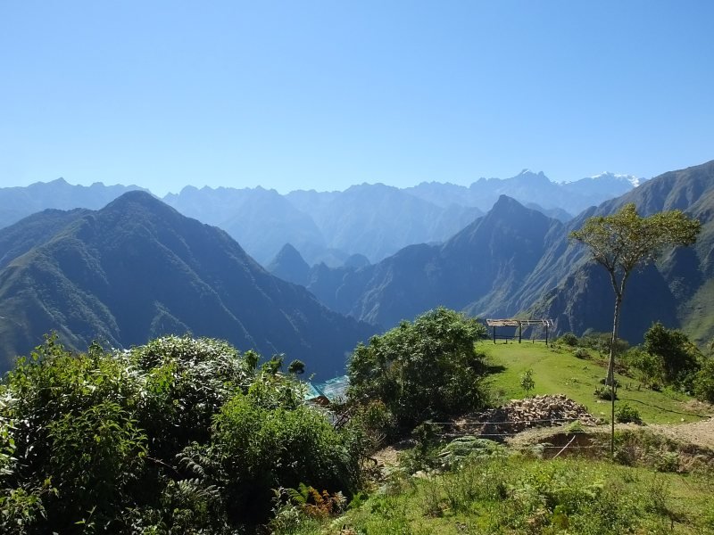View across forested mountains toward Machu Picchu from the Salkantay trek near Llactapata