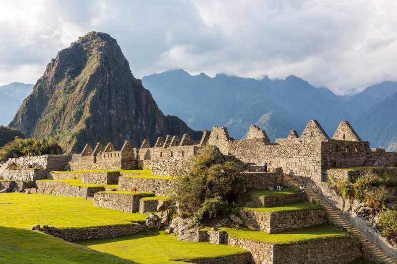 Stone houses and terraces of Machu Picchu with Huayna Picchu rising behind