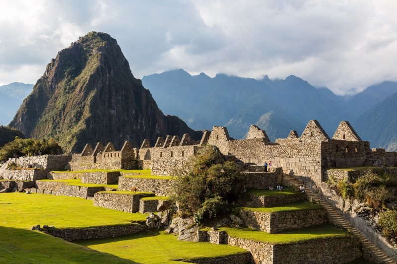 Gabled stone buildings of the urban sector of Machu Picchu below Huayna Picchu