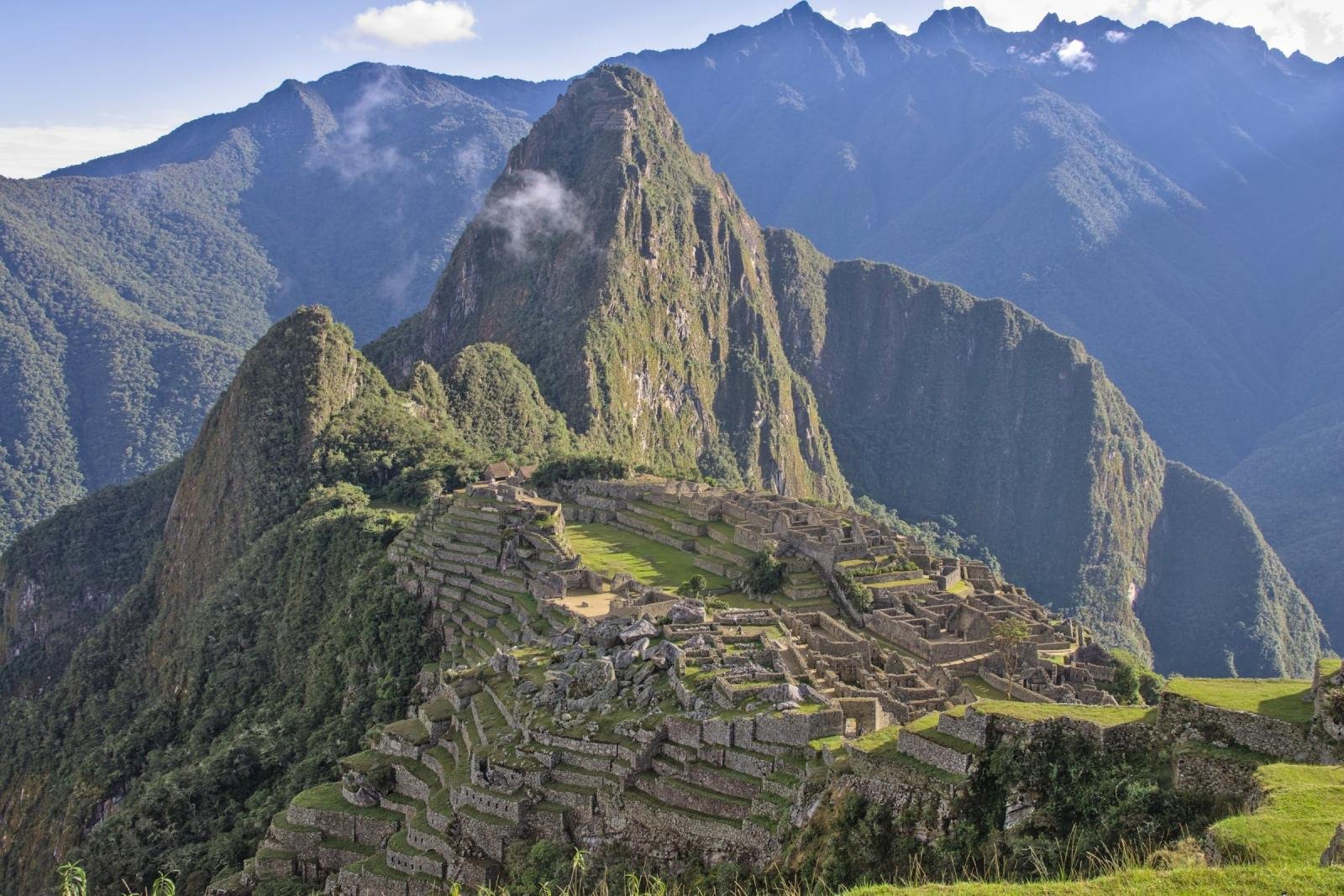 Machu Picchu and Huayna Picchu on a clear May morning with green terraces