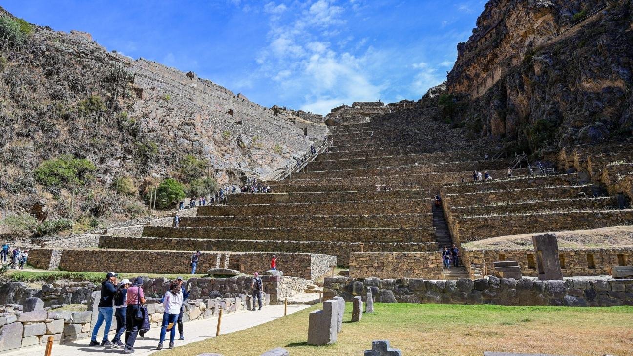 Ollantaytambo terraces Visitors climbing the stone terraces of the Ollantaytambo temple hill