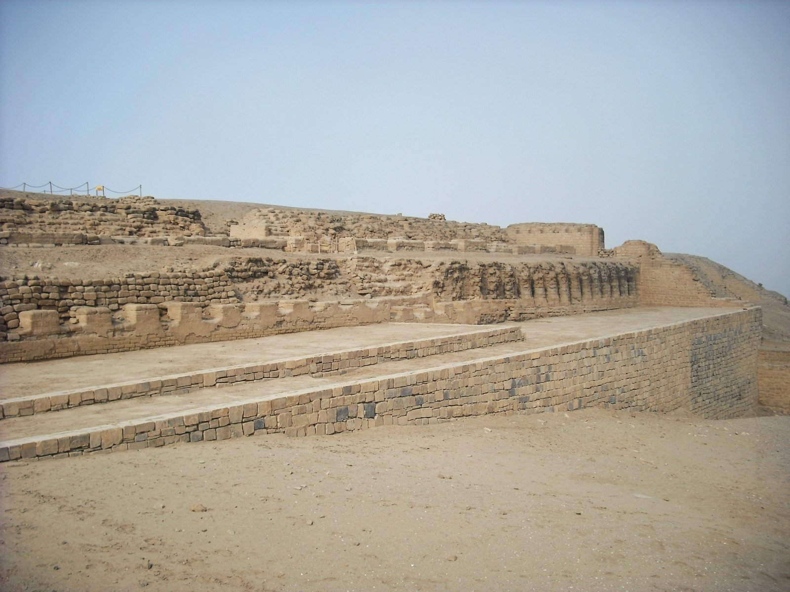 Terraced adobe platforms of the Temple of the Sun at Pachacamac under a clear sky