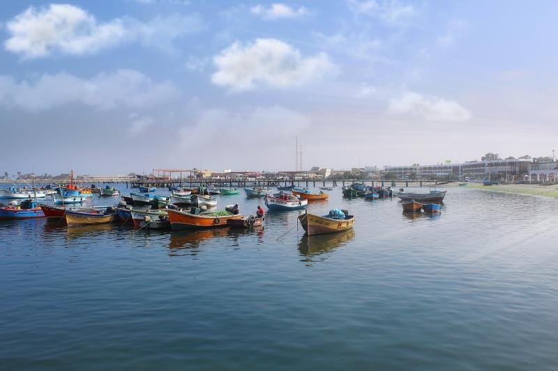 Fishing boats on the calm bay of Paracas under a blue sky