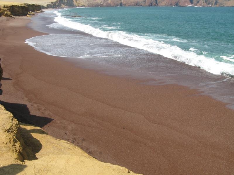 Playa Roja with its red sand and turquoise Pacific waves in the Paracas reserve