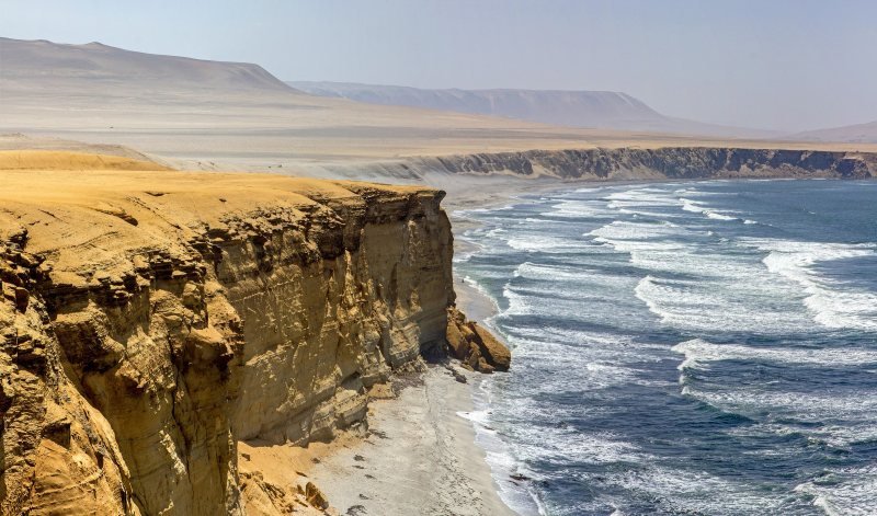 Ochre desert cliffs above the Pacific in the Paracas National Reserve
