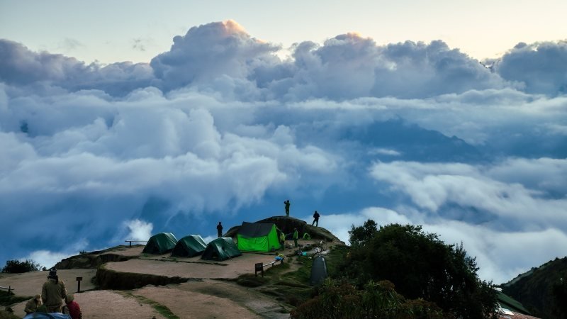 Tents at the Phuyupatamarca campsite above a sea of clouds on the Inca Trail