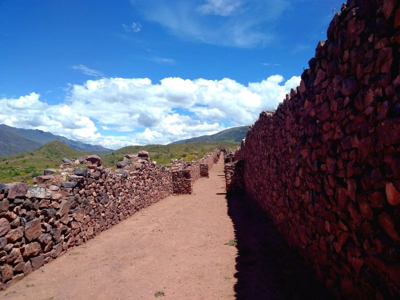 A long straight street between high stone walls at Pikillacta