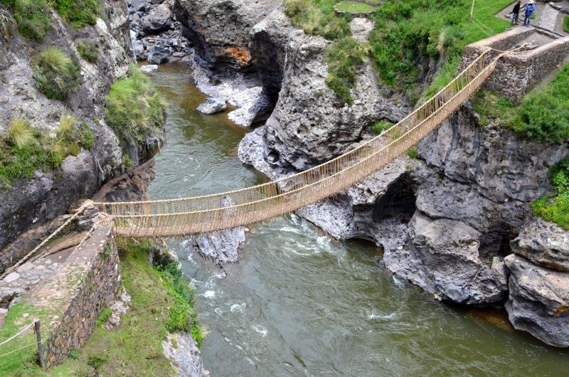 The Qeswachaka grass rope bridge spanning the Apurimac river between rock walls