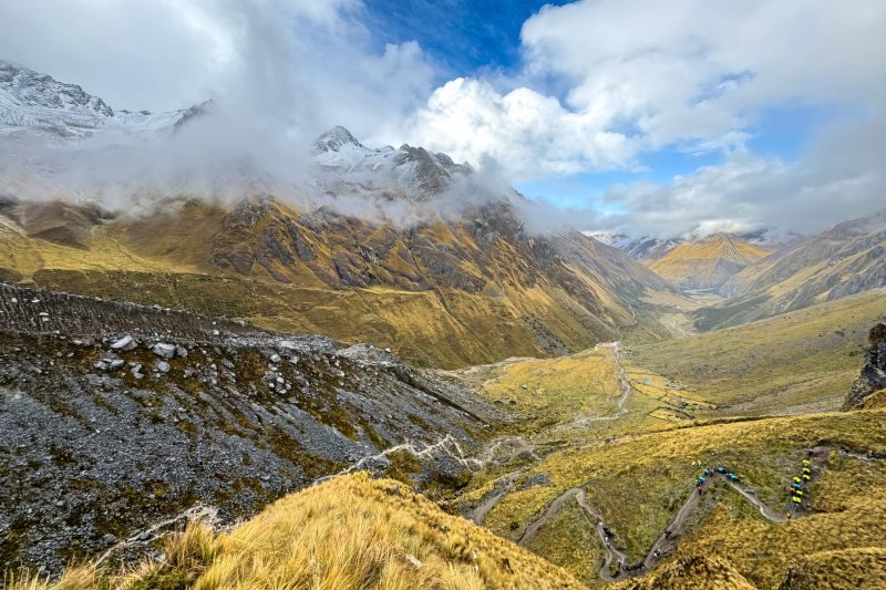 Trail switchbacks climbing toward the Salkantay Pass below snow peaks
