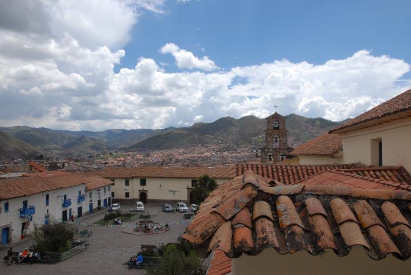 Clay tile rooftops of the San Blas neighborhood looking over Cusco to the hills