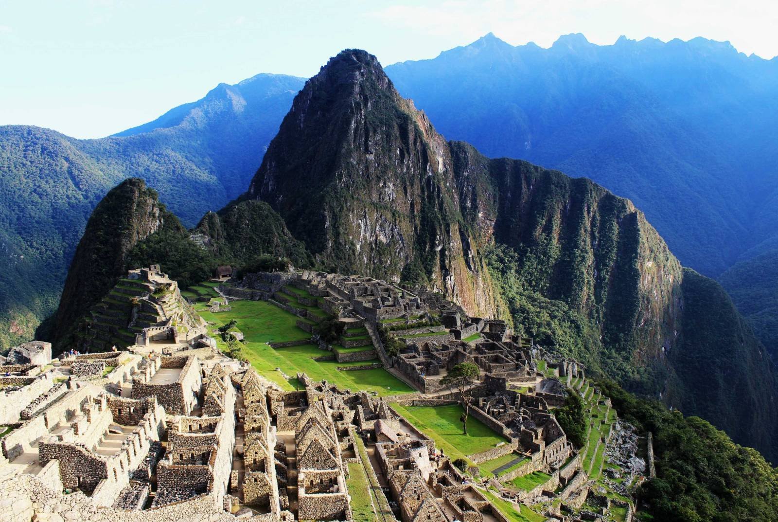 Machu Picchu under a deep blue September sky, with Huayna Picchu above the green main plaza