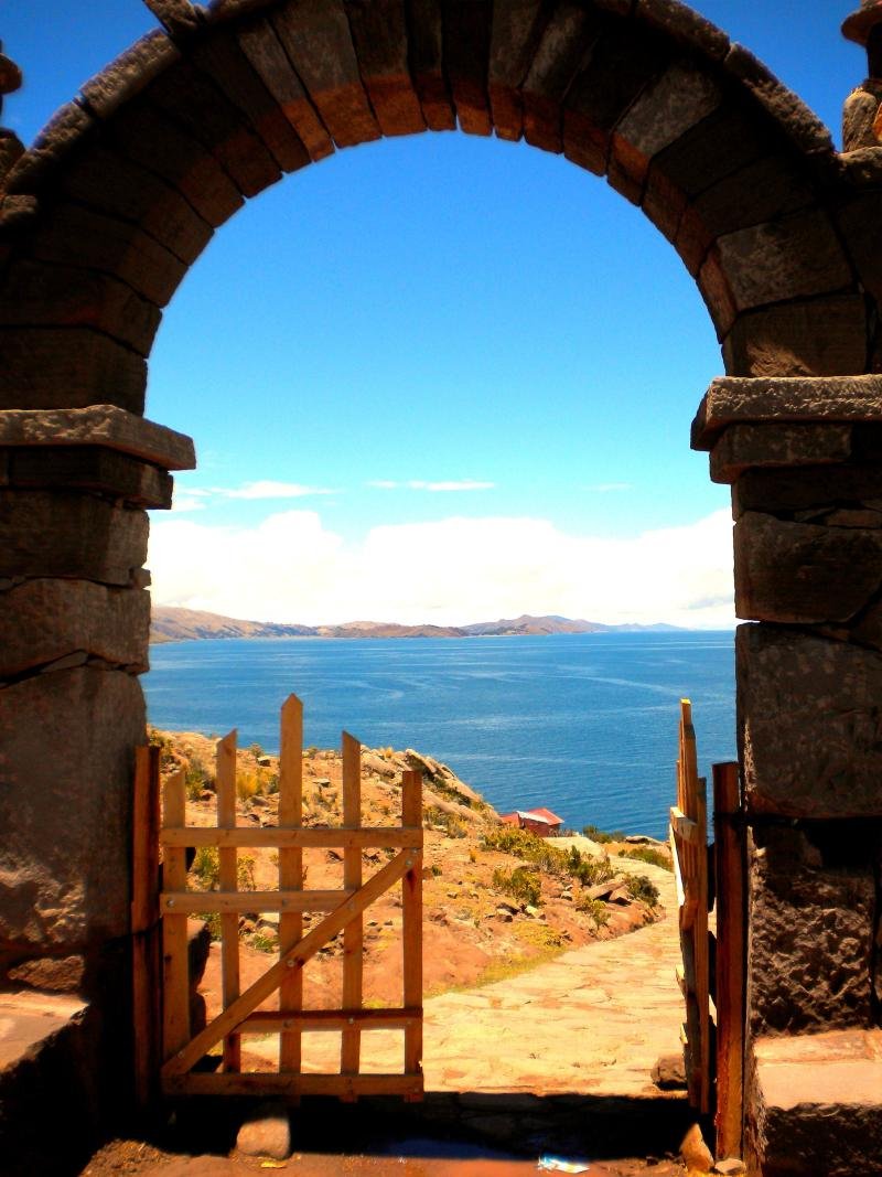 Stone archway on Taquile island framing Lake Titicaca