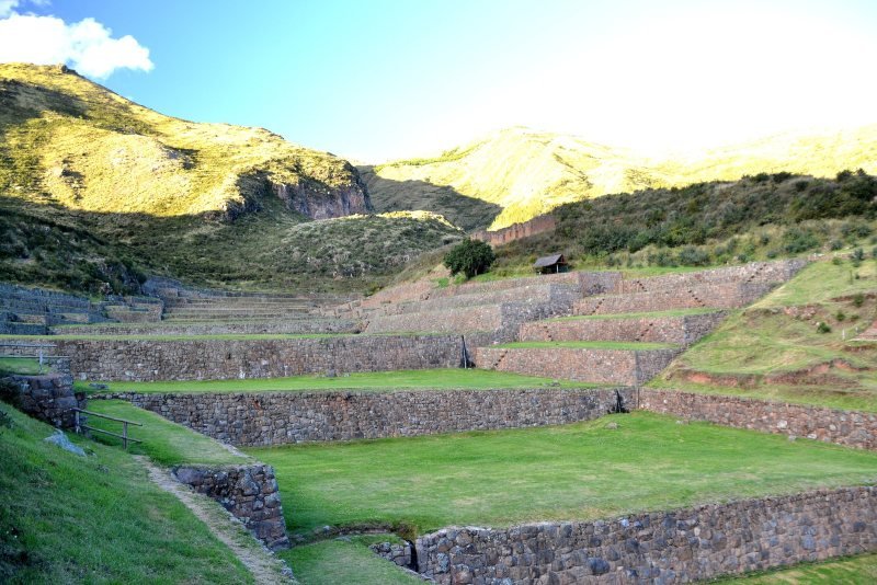 Grass-covered Inca terraces and water channels at Tipon