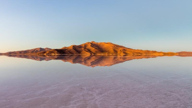 Salar de Uyuni at dusk Mountain reflected in the flooded Salar de Uyuni at dusk