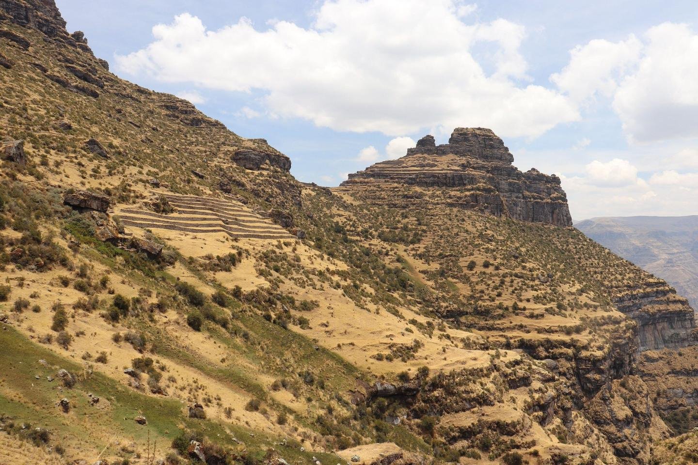 Waqrapukara fortress on a rock spur above the canyon, with terraces on the slope